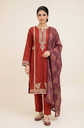 Woman wearing a red traditional outfit with a matching dupatta on a beige background